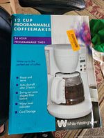 Front of boxed White Westinghouse 12-cup programmable coffeemaker showing product image and features