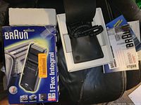 Razor, box, pouch, cord and manual laid out