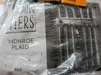 Factory-sealed package showing Monroe Plaid label and plaid pattern