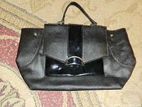 Front view of black Nine West handbag with patent accent