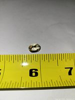 Top view of citrine against measuring tape for scale