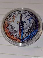 Front of enamel silver token showing sword image and legend