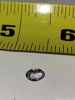 Gemstone beside tape measure showing approx 7 mm width