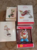 Group shot of four boxed Hallmark ornaments
