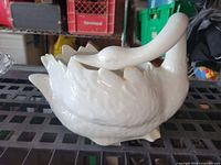 Overall view of white ceramic swan planter left side