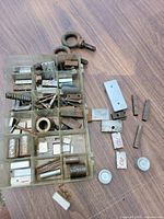 Overall view of organizer tray with assorted machinist pieces, additional items set beside tray