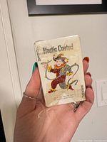 Front of sealed deck showing joker illustration and plastic wrap wear