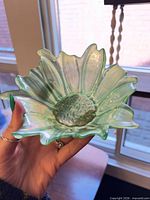 Front view of green iridescent sunflower-shape bowl