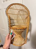 Front view of miniature rattan wicker chair showing overall design