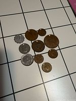 All eleven coins grouped together on grid surface