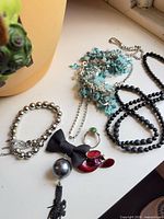Group view of bracelet, necklaces, pendants, ring