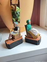 Both carved and painted wooden figurines on display