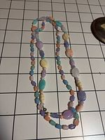 Full view of entire necklace showing double strand loop and pastel bead variety