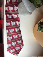 Entire length of red tie showing sheep pattern