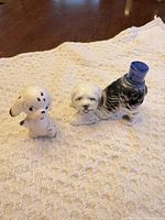 Both dog figurines side by side on cloth
