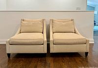 Front view of both beige Baker lounge chairs