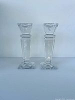 Front view of both clear faceted candlesticks