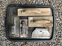 Tray with five cement and plaster hand tools