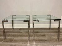 Front view of both glass and chrome end tables