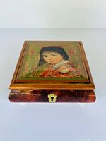 Top view showing hand-painted portrait panel set in wood lid
