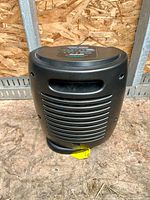 Front view of black EnergySmart space heater with grille and cord