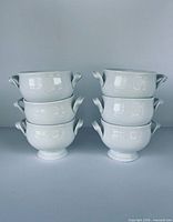 Six white porcelain onion soup bowls stacked