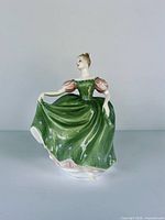 Front view of porcelain figurine in green dress