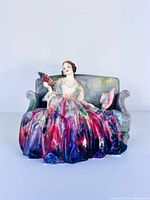 Front view of Royal Doulton Sweet & Twenty figurine on sofa