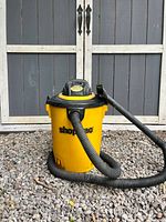 Full view of yellow Shop-Vac with hose and wand