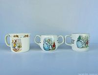 Front view of three Peter Rabbit baby mugs/cups