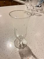 Single etched starburst cordial glass on countertop