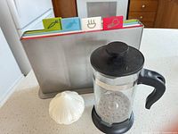 French press, cutting boards in stand, garlic keeper overview