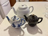 Group shot of all three teapots showing relative sizes and colors