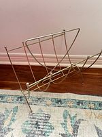 Full view of brass magazine rack showing overall design