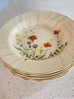 Stack of five Mikasa Margaux ivory floral rim soup bowls
