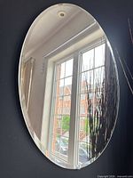 Front view of oval mirror on wall