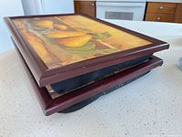 Stacked view of both lap trays showing wooden frames and side profile