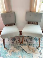 Front view of both mid-century modern armless chairs