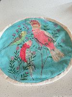 Front of teal pillow cover with bird and flowers