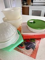 Group shot of all plastic bowls, containers and lids on countertop