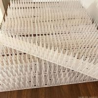 Overhead view showing multiple white plastic bird spike strips stacked