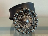Front view showing leather strap and decorative buckle