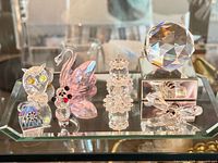 Group shot showing owl, panda fragment, swan, pillar pair, bee, sphere on pedestal and rectangular mirrored base