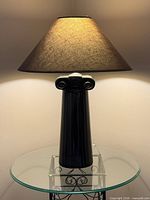 Full view of lamp lit on glass table