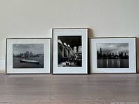 Front view of three framed black-and-white New York City photographs