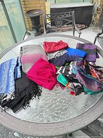 Group view of all scarves on glass table