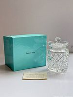 Jam jar with lid beside Tiffany blue box and product card
