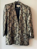 Front view of metallic gold and black paisley blazer on hanger