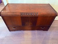 Front view of cedar blanket chest showing top compartment area and lower drawer