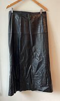 Front view of black leather midi skirt on hanger